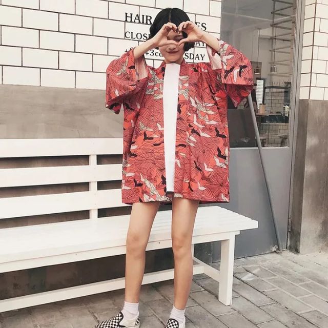 Oversized crane kimono cardigan in red with all-over bird print worn as open street style jacket