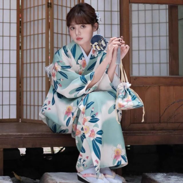 Floral kimono with teal and pink flower pattern worn in a traditional setting