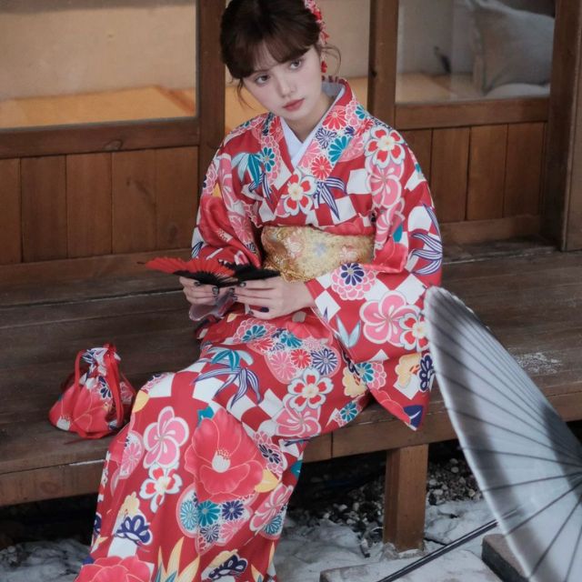 Elegant red kimono with white floral design styled in a traditional setting