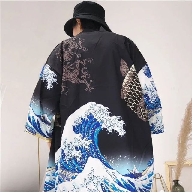 japanese wearing black kimono with wave and fish design against a light brick wall - eiyo kimono