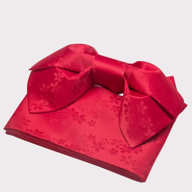 Red obi sash tied in decorative bow over white floral kimono — Japanese jacquard polyester belt