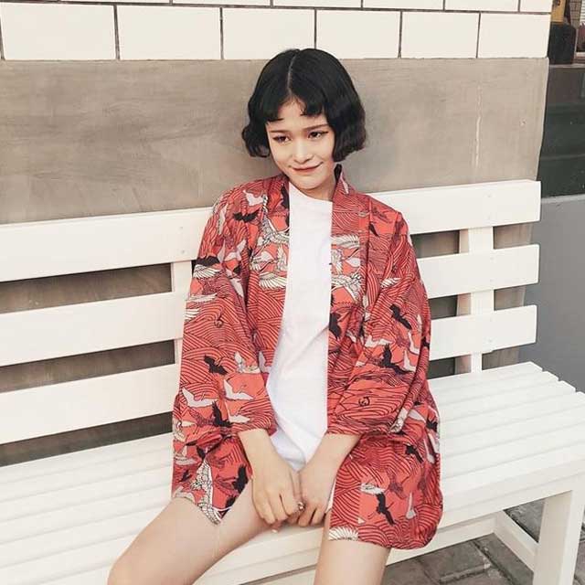 Oversized crane kimono cardigan in red with all-over bird print worn as open street style jacket