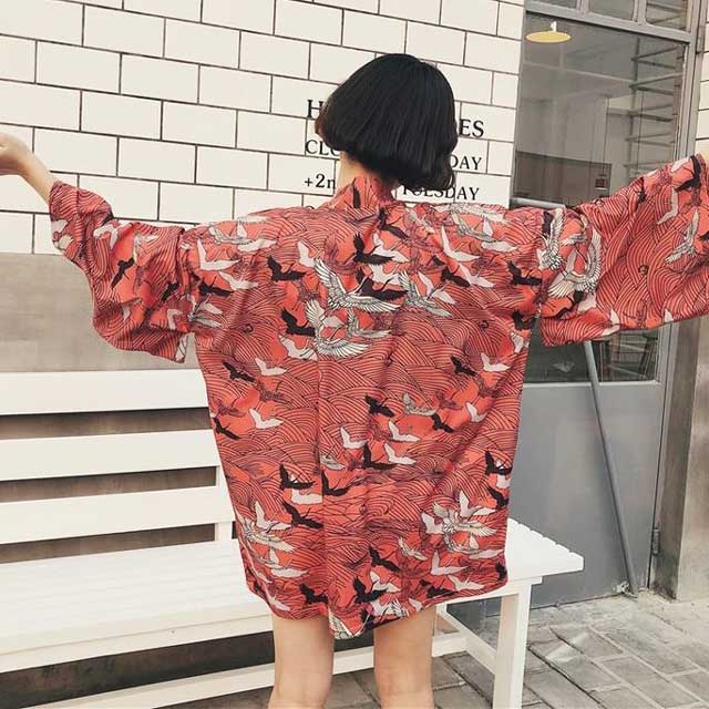 Oversized crane kimono cardigan in red with all-over bird print worn as open street style jacket
