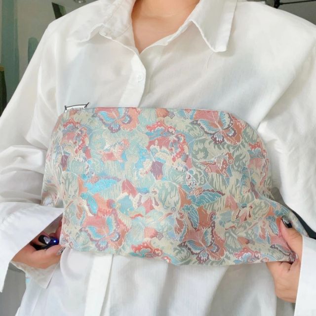 Wide kimono belt with soft floral pattern tied at the waist