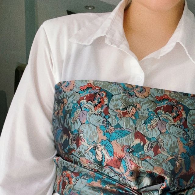 Wide kimono belt with teal floral pattern tied at waist