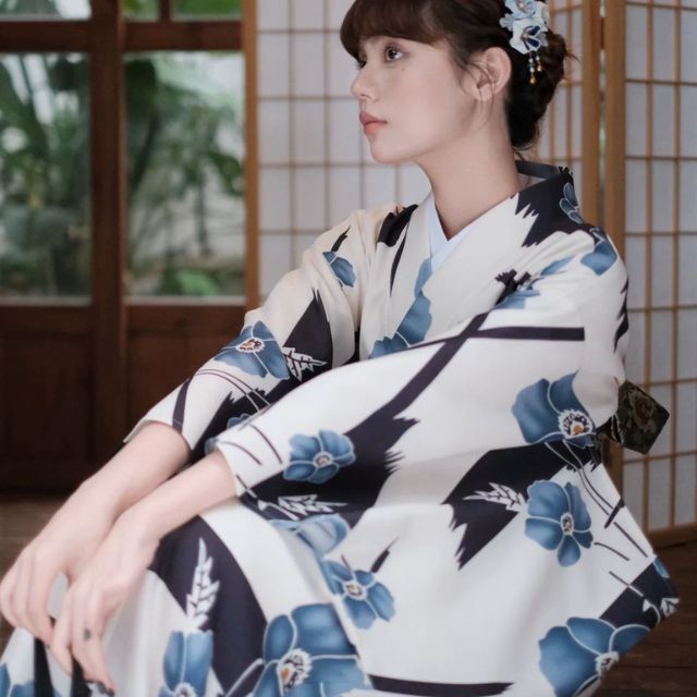 Japanese kimono dress with blue floral pattern and traditional wide sleeves