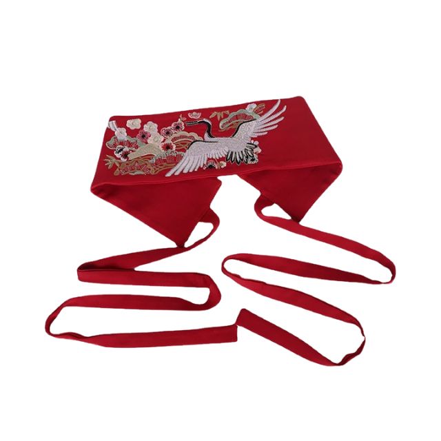 Embroidered kimono sash belt with crane design tied around waist