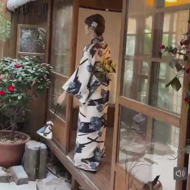 Japanese kimono dress with blue floral pattern and traditional wide sleeves
